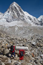 Porters carrying all sorts of luxuries in to Everest Base Camp. Pumori in the distance