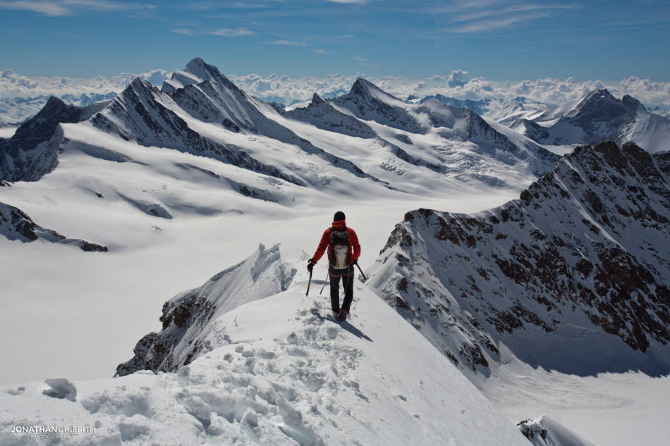 Ueli heading back down the normal route of the Monch with the Oberland stretching as far as the eye can see