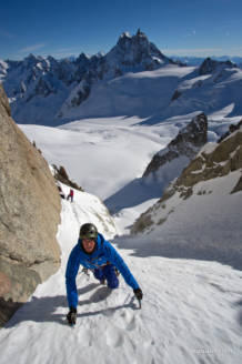 Max questing out of the sun and in to the cold couloir with the Grandes Jorasses in the backgorund