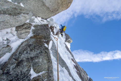 Korra climbing 90 degree ice with just one axe