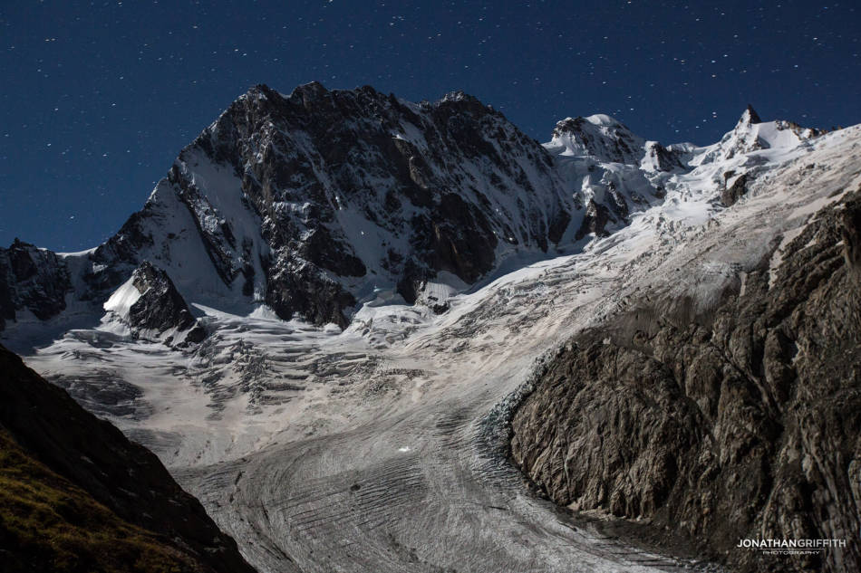 The Grandes Jorasses North Face and a stream of head torches already high up on the face