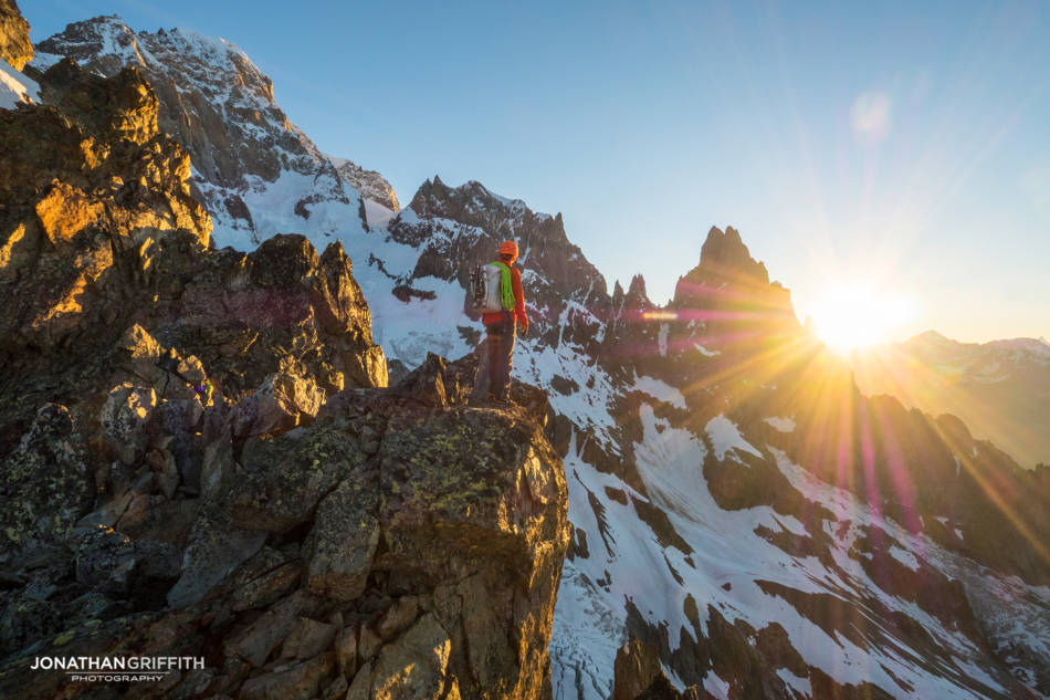 Ally takes in the sunrise over the Peuterey Integral from the Aiguilles Rouges du Brouillard