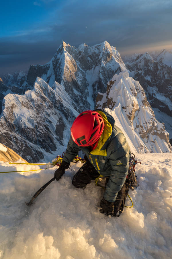 Andy, on his knees, hacking out a bivy ledge after a huge day out