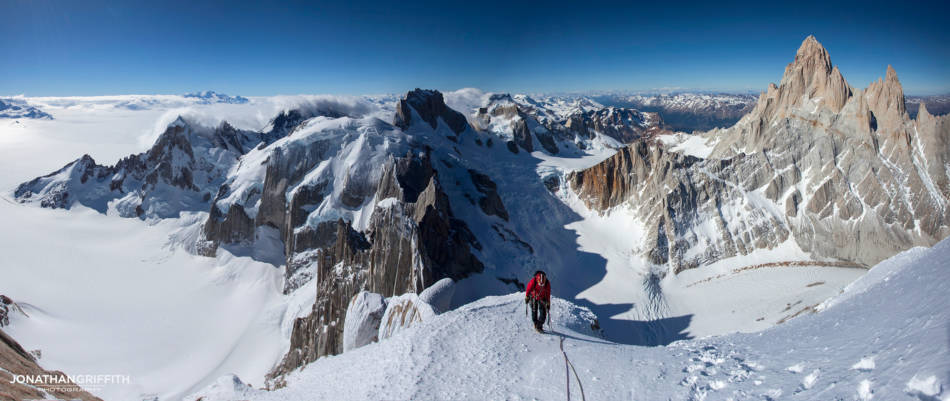 If the vista is big then shoot a panoramic image- don't be afraid of showing where you are!